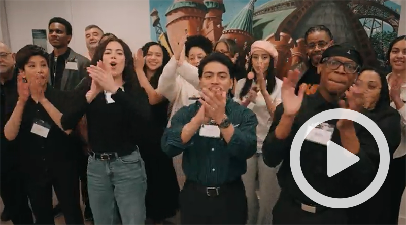 Clickable video still showing group clapping