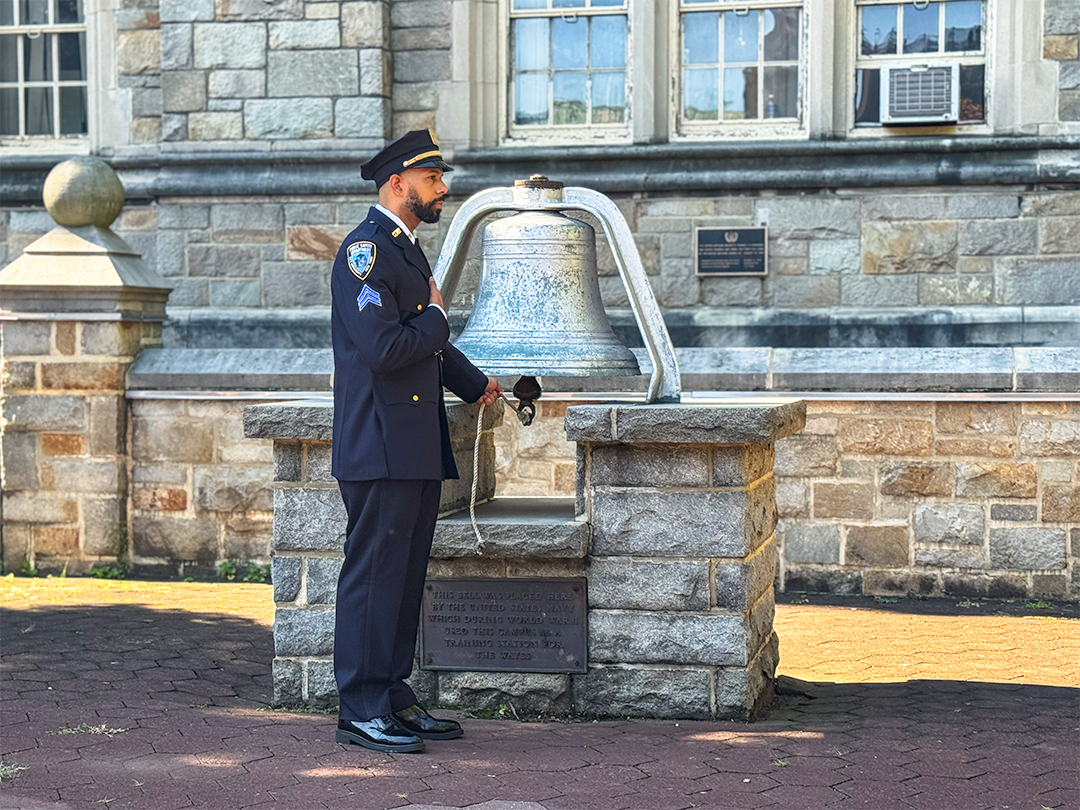 Photo of campus officer ringing bell during 911 event