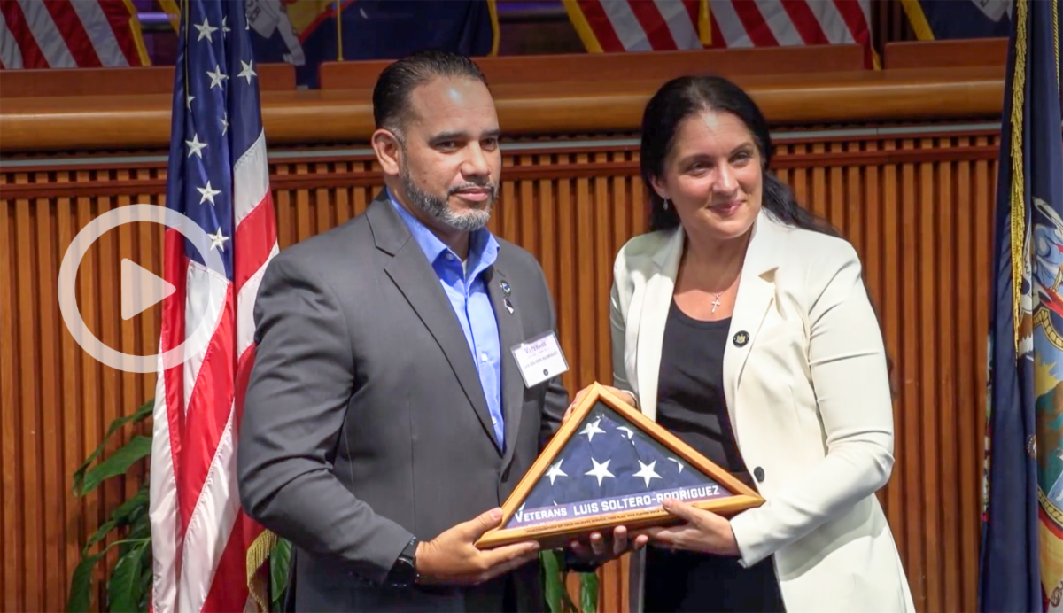 Director of Lehman's Office of Veterans and Military Affairs Luis Soltero-Rodriguez receiving award
