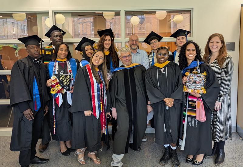 Group Poses for photo in caps and gowns