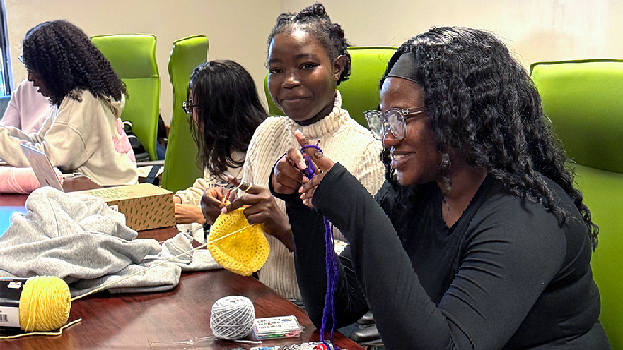Photos of student crocheting at club event