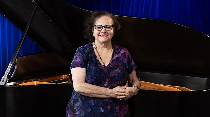 Penny poses with piano