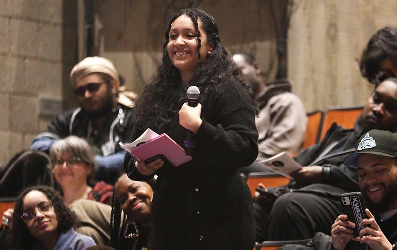 Student holding microphone smiling