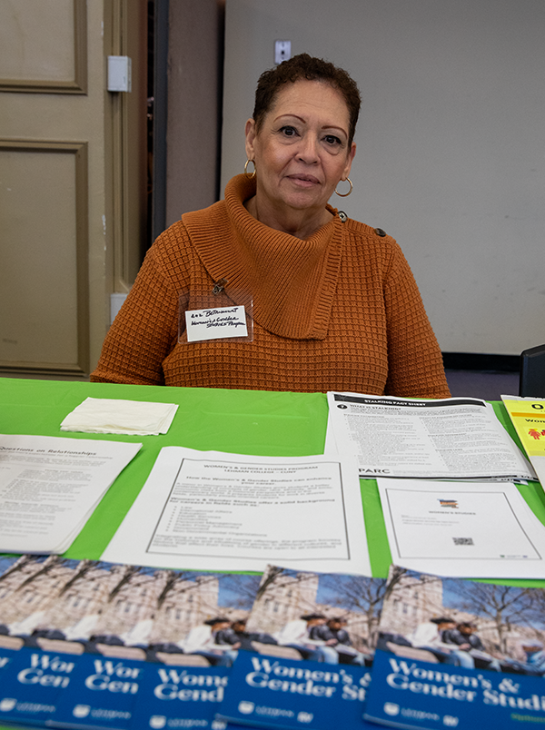 Prof at table - women's studies brochures