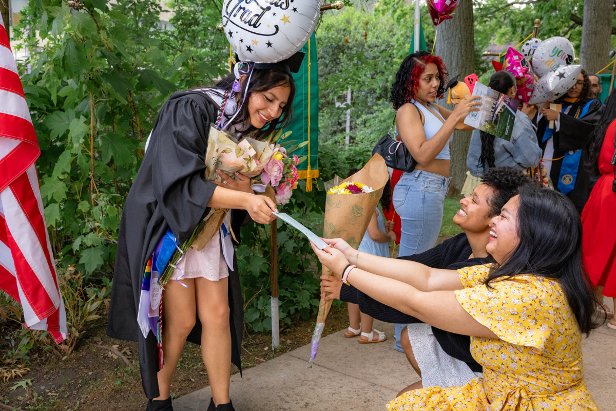 Friends surprising female student with flowers and gifts