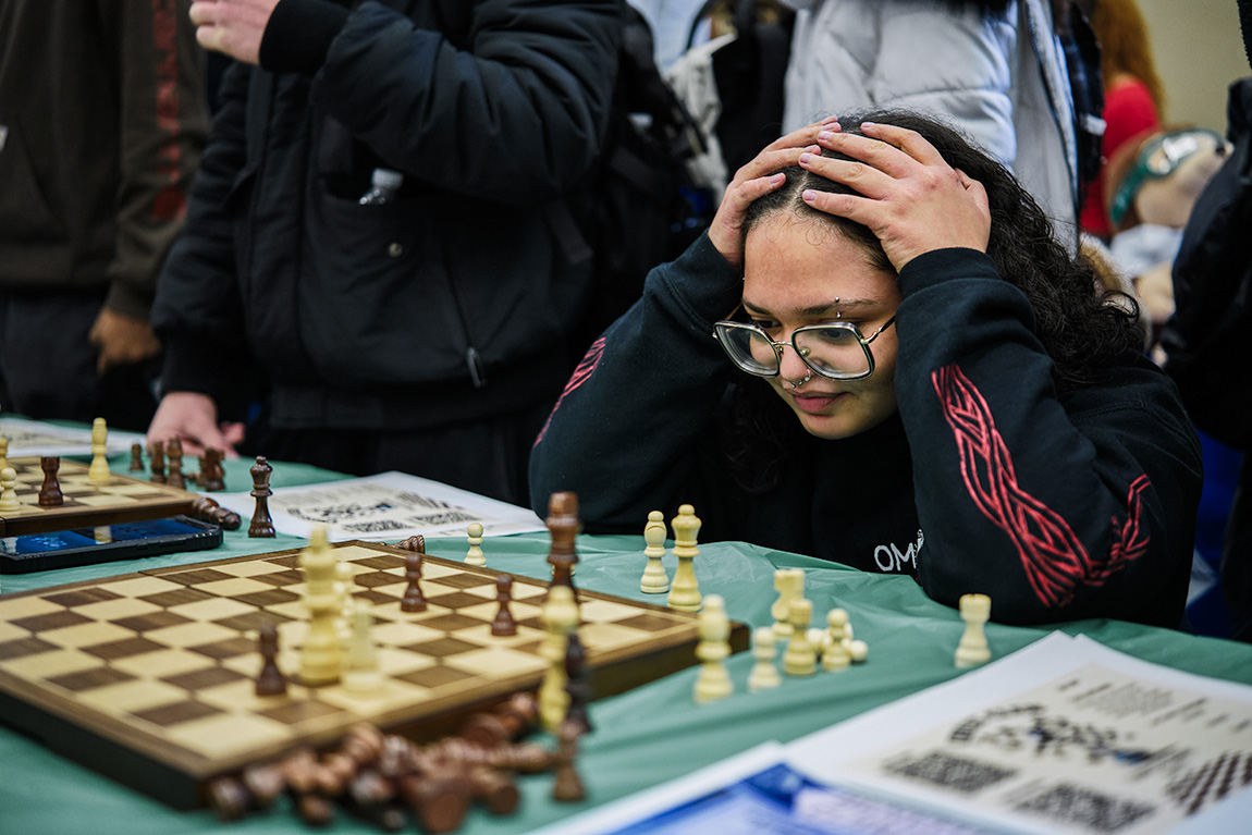 Student with Hands on Head playing chess
