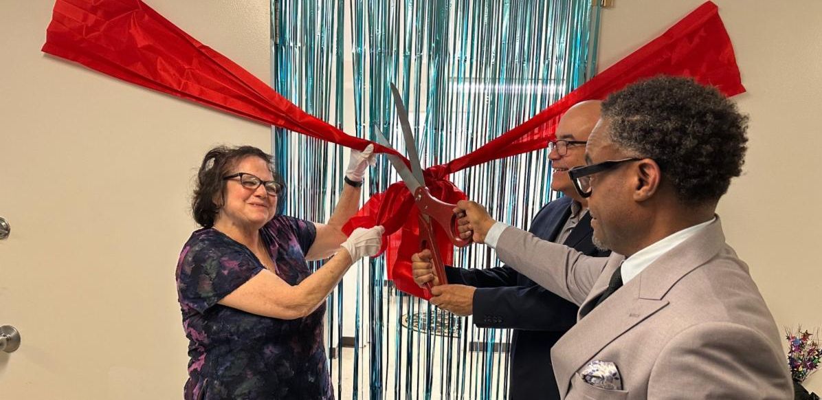 Red Ribbon Being Cut in the Center's New Space