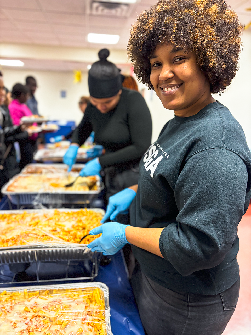 Photo of student volunteer serving meals