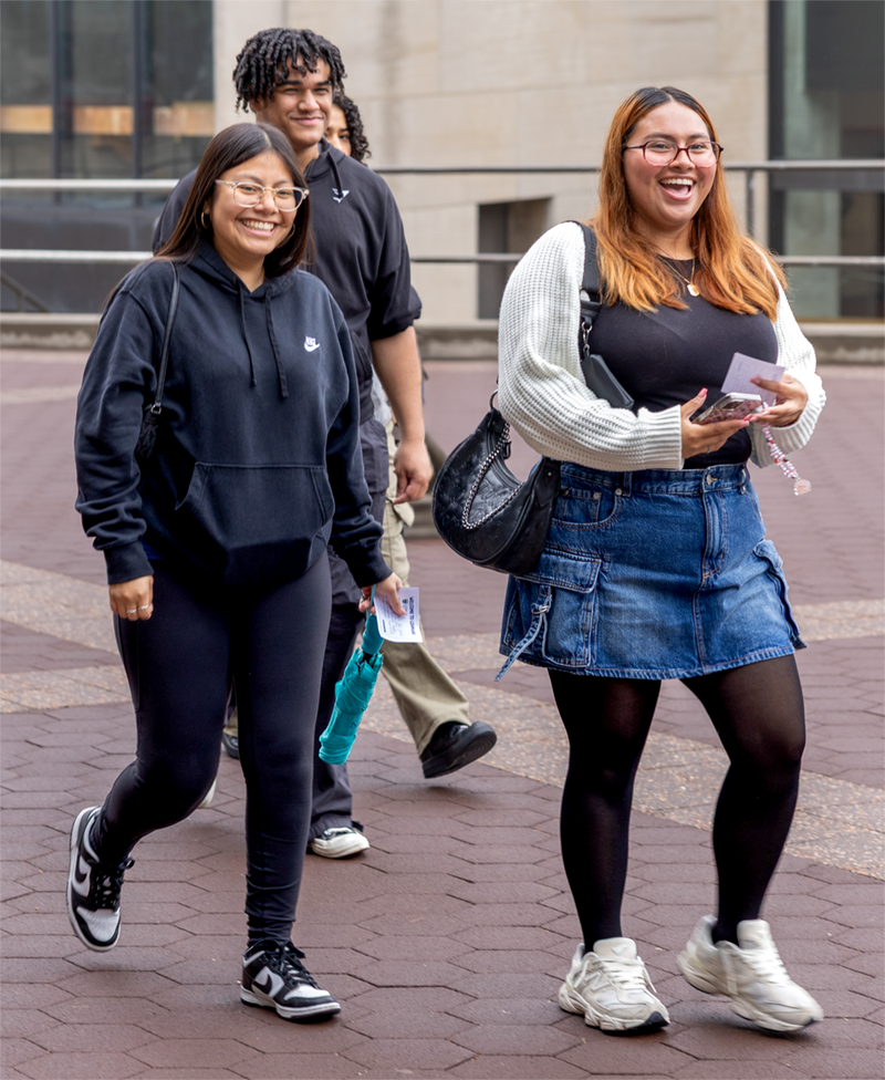 Image of new Lehman's students walking and smiling on campus
