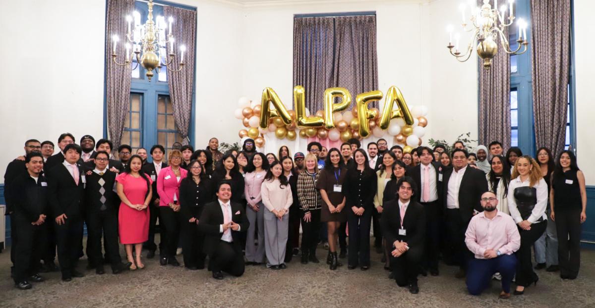 Large group shot with metallic ALPFA balloons in the background