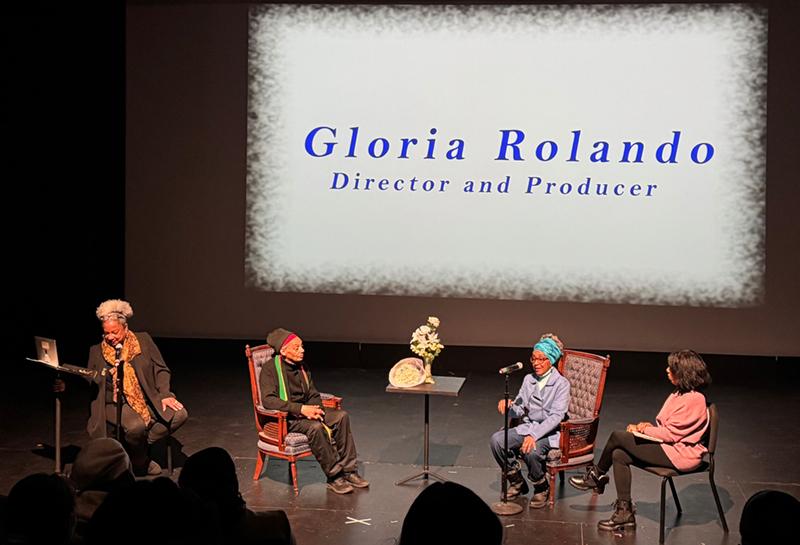 Four People on Stage Conversing