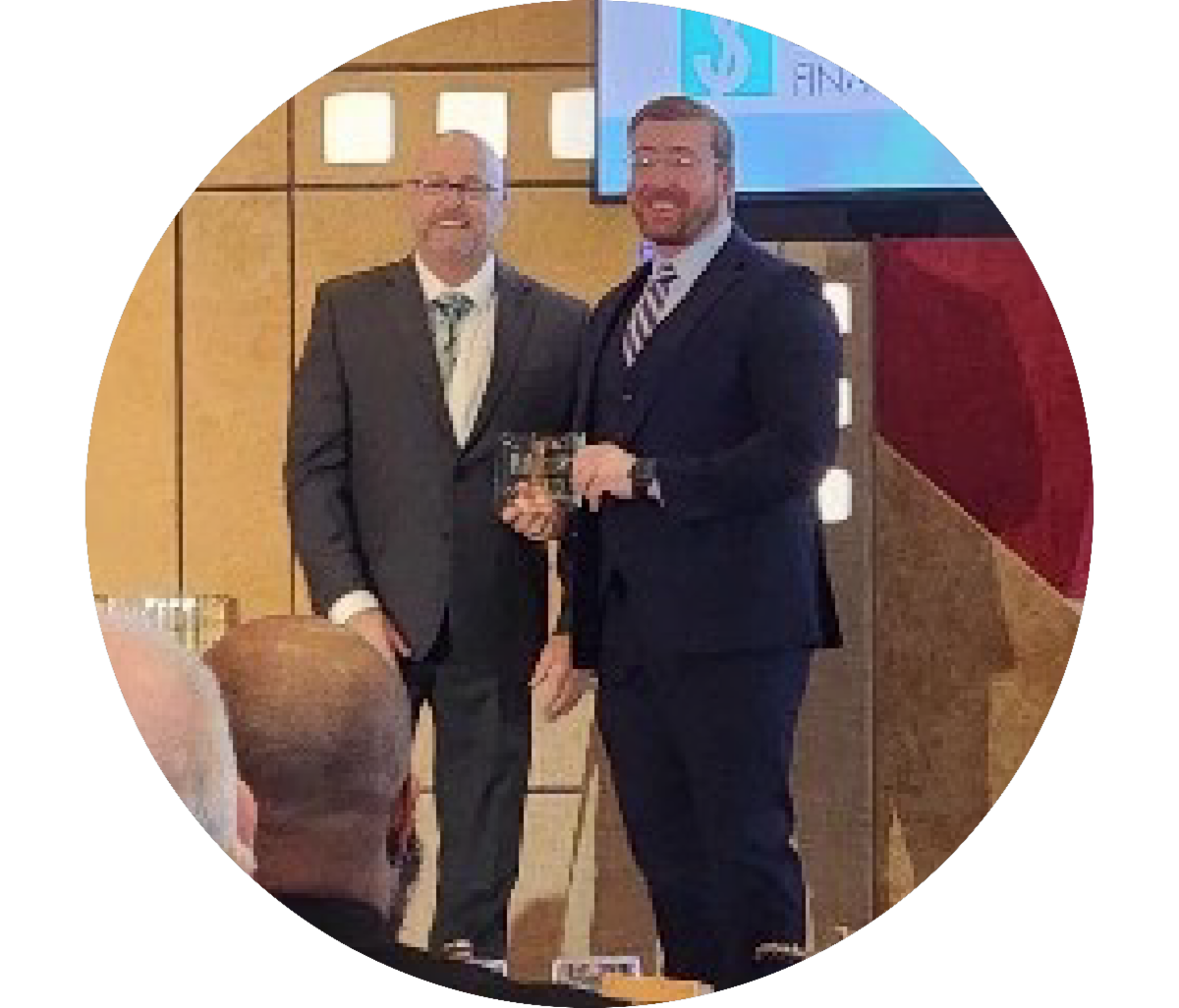 Professor with award on stage