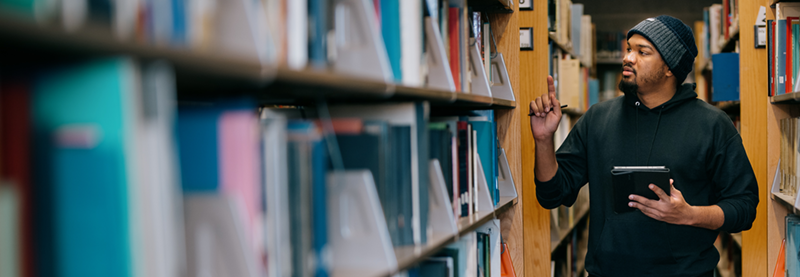 Student in the Stacks finding a book