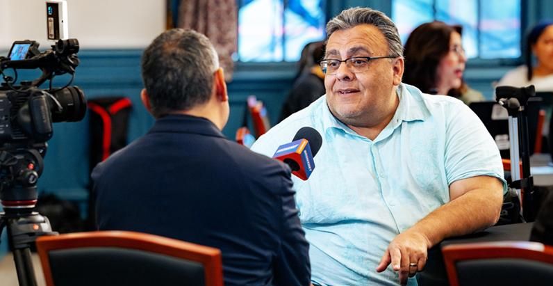 Delgado being interviewed with a microphone