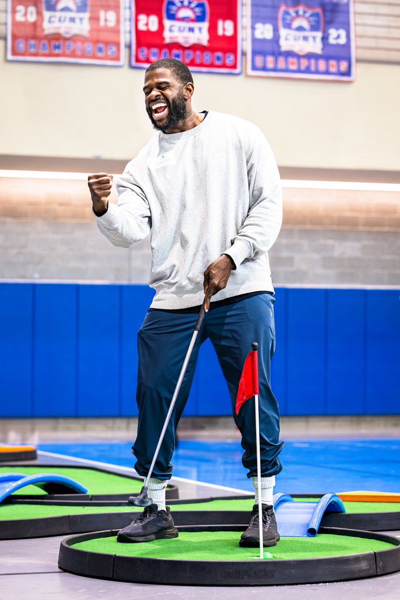Student plays mini golf - celebrates 