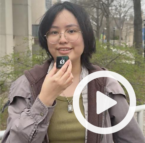 Clickable video still showing a student speaking into a microphone