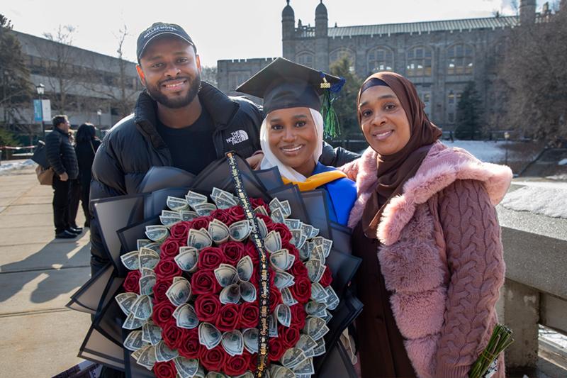 Photo of graduate with a bouquet of money