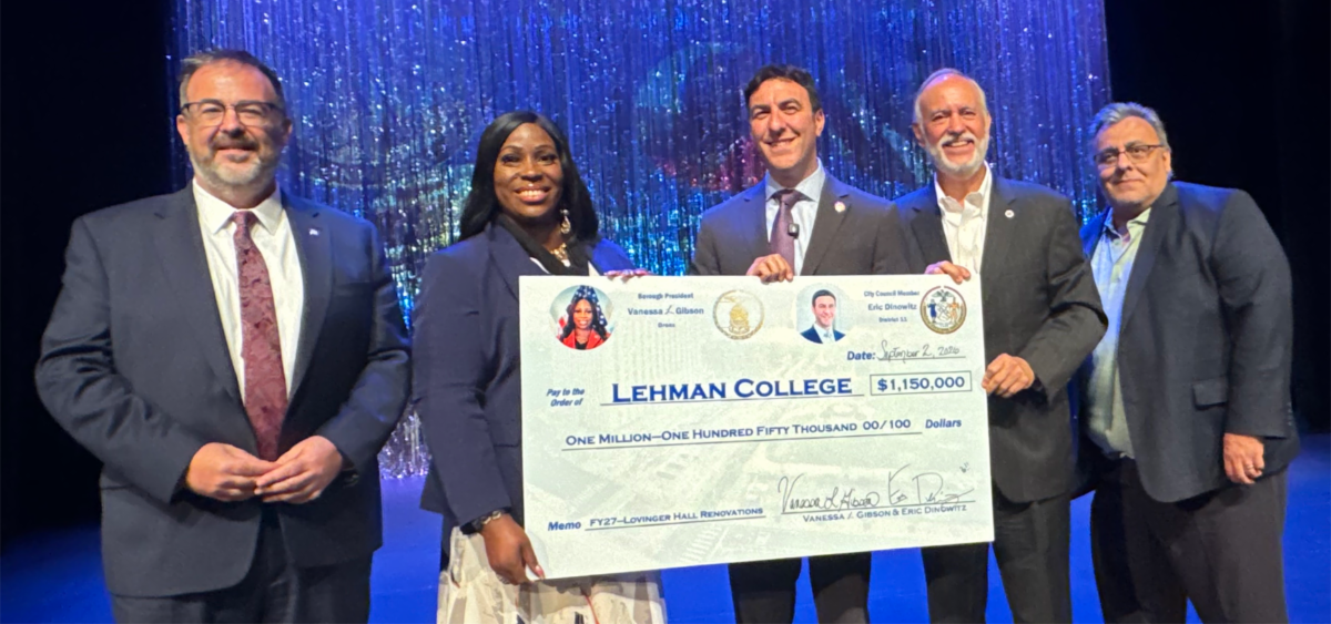 VIPs hold the giant check including the signatories and President Delgado and CUNY Chancellor