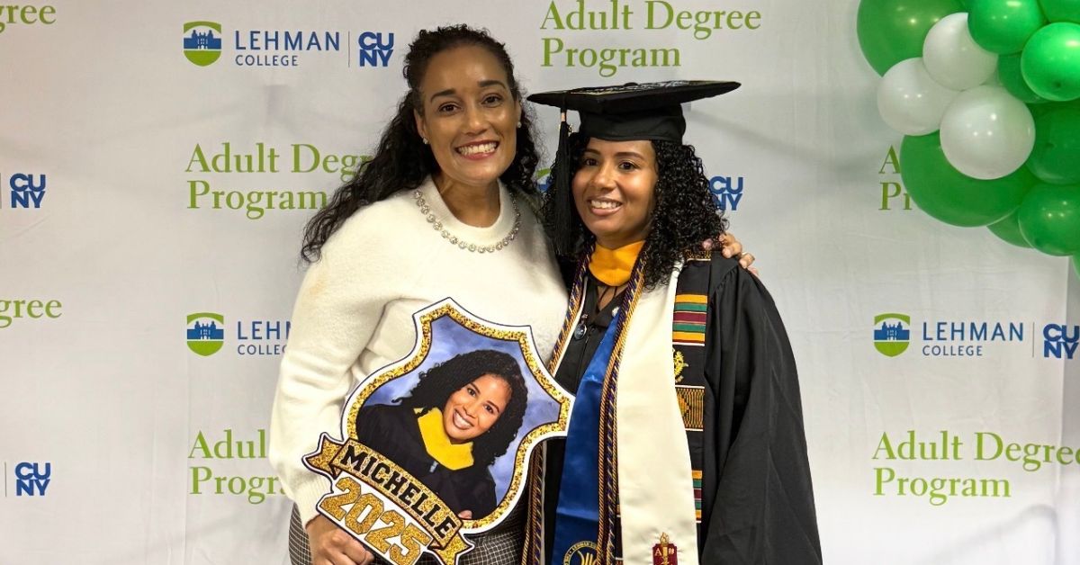 ADP graduate named Michelle poses for a photo in front of step and repeat