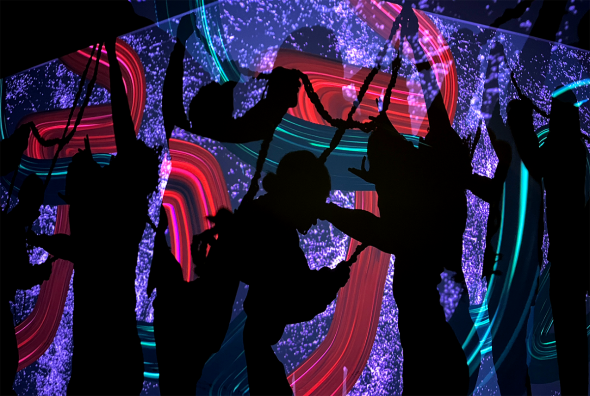 Colorful backdrop and silhouetted dancers