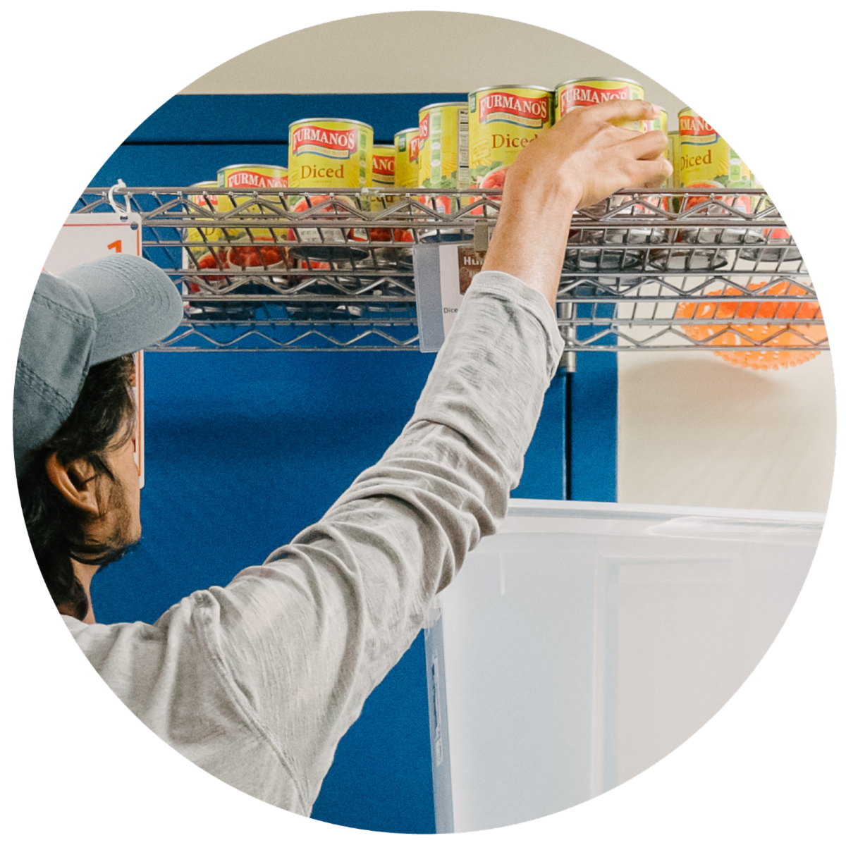 Student reaches for can at food bank