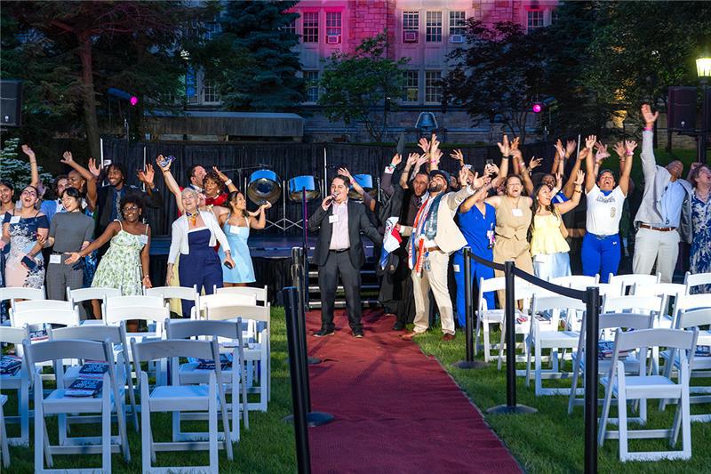 Singing and Dancing with a pink glow in the background