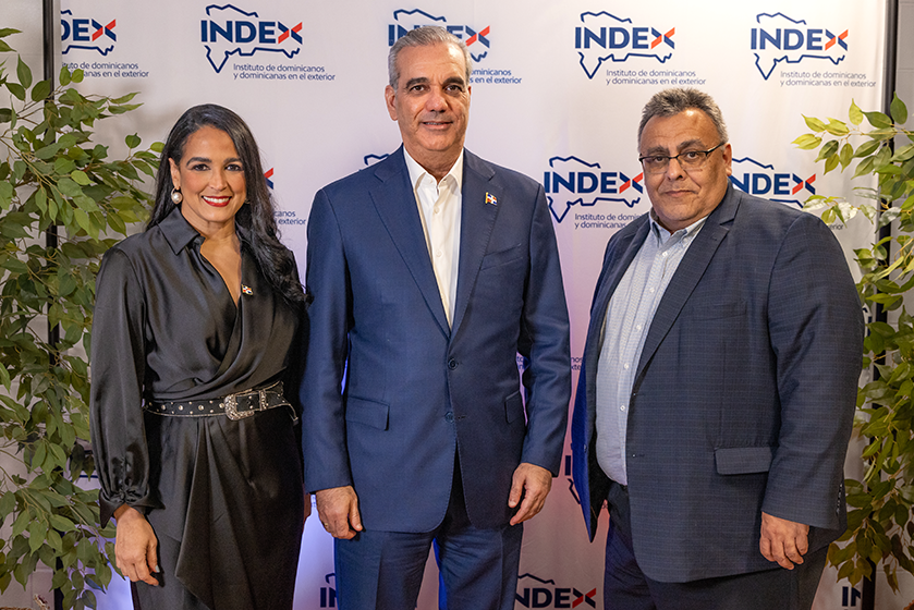 Three VIPs stand in front of INDEX Step and Repeat