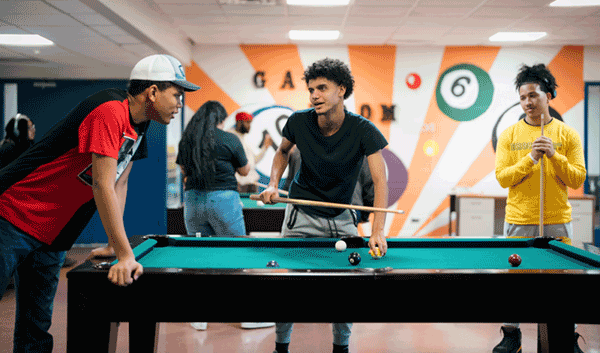 Image of students playing pool at Lehmans' student life center.