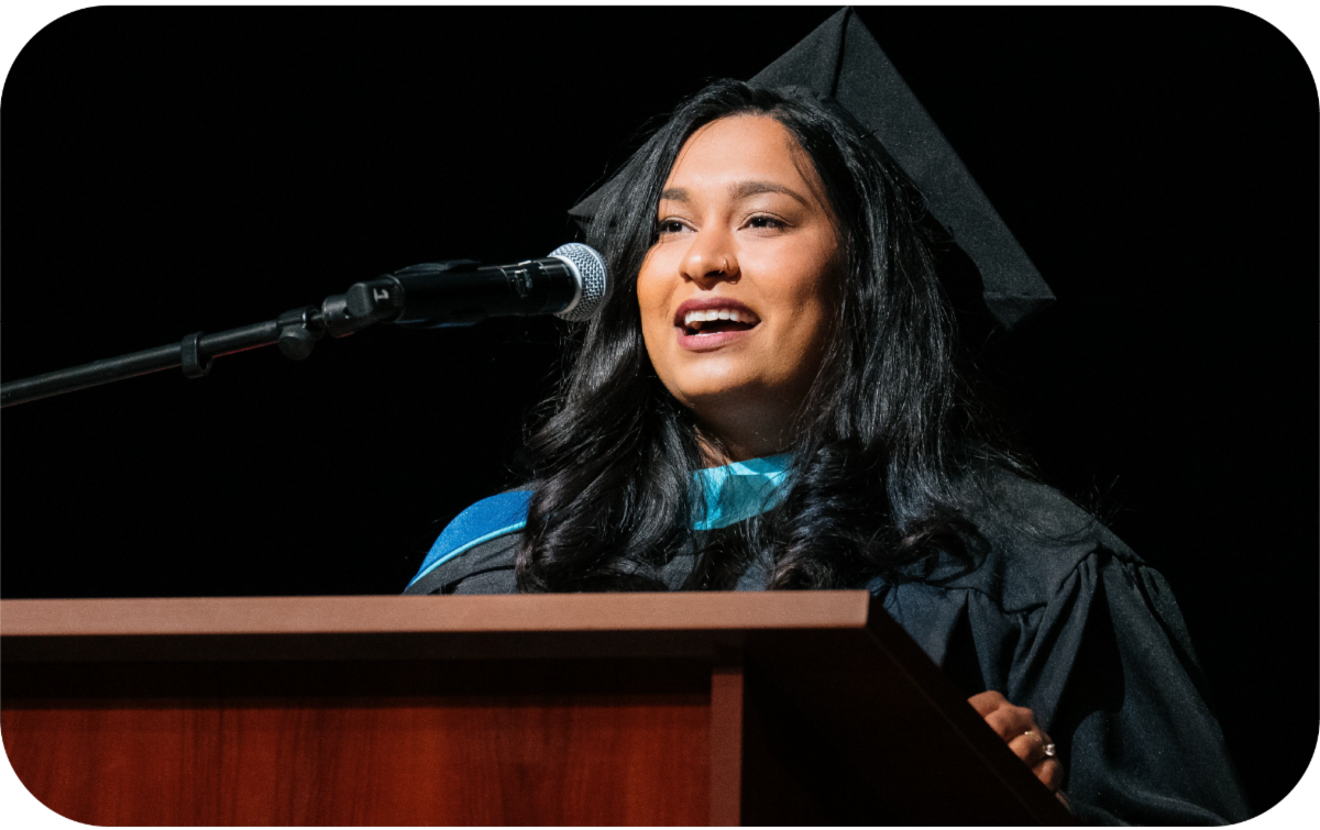 Graduate Student Speaker at microphone