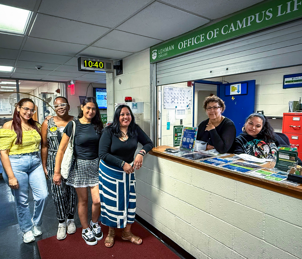 Image of workers and students standing at the window of Office of Campus Life