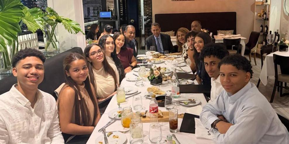 Professor at table with students