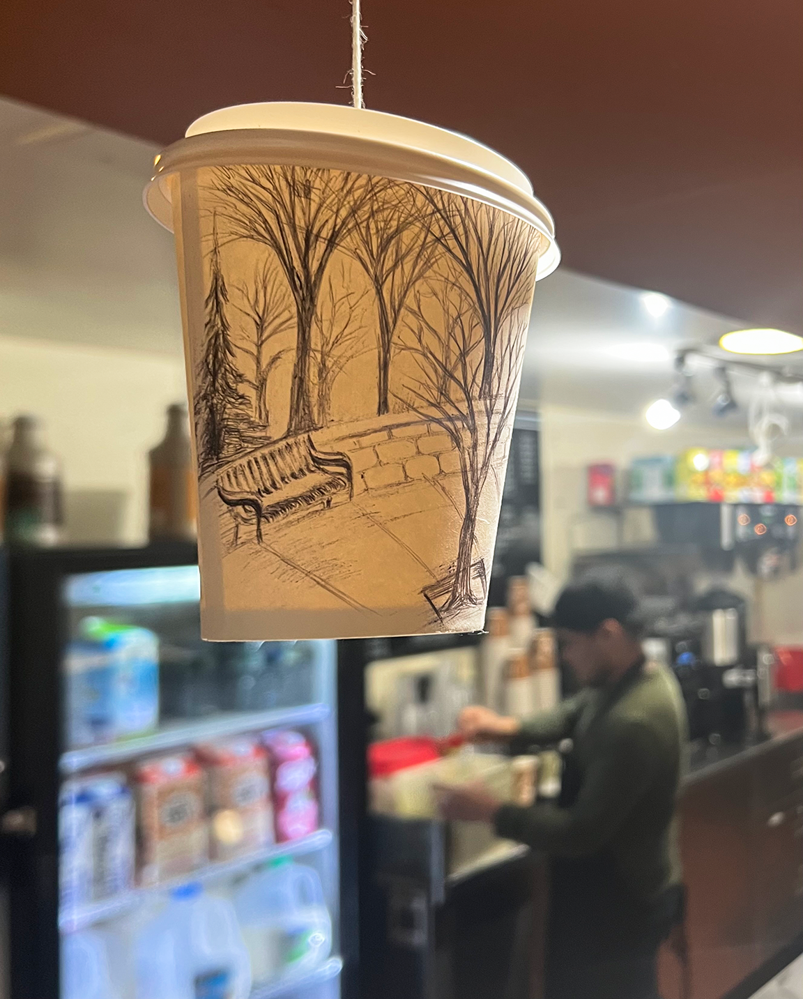 Disposable Coffee cup with illustration of campus benches and trees