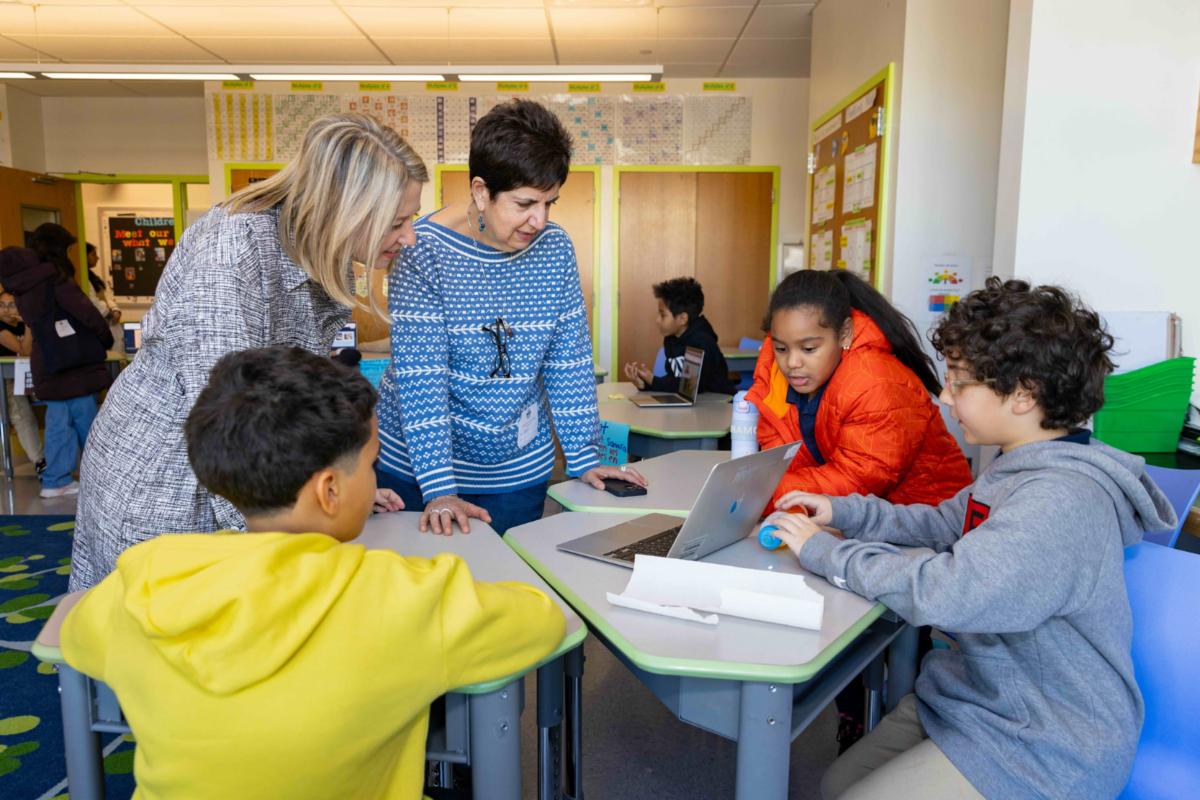 Teachers with young students in classroom