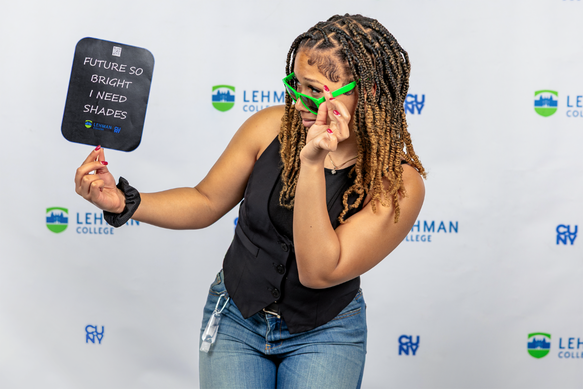 Woman in green sunglasses holds future so bright sign