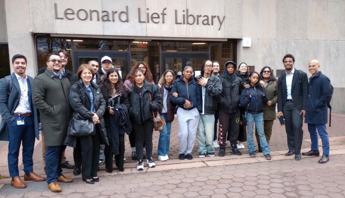 Group poses in front of library