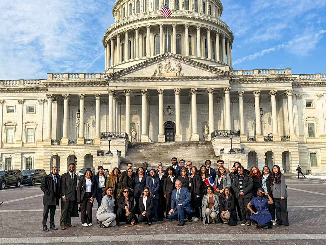 Large group of well-dressed Lehman students in front of the capitol building