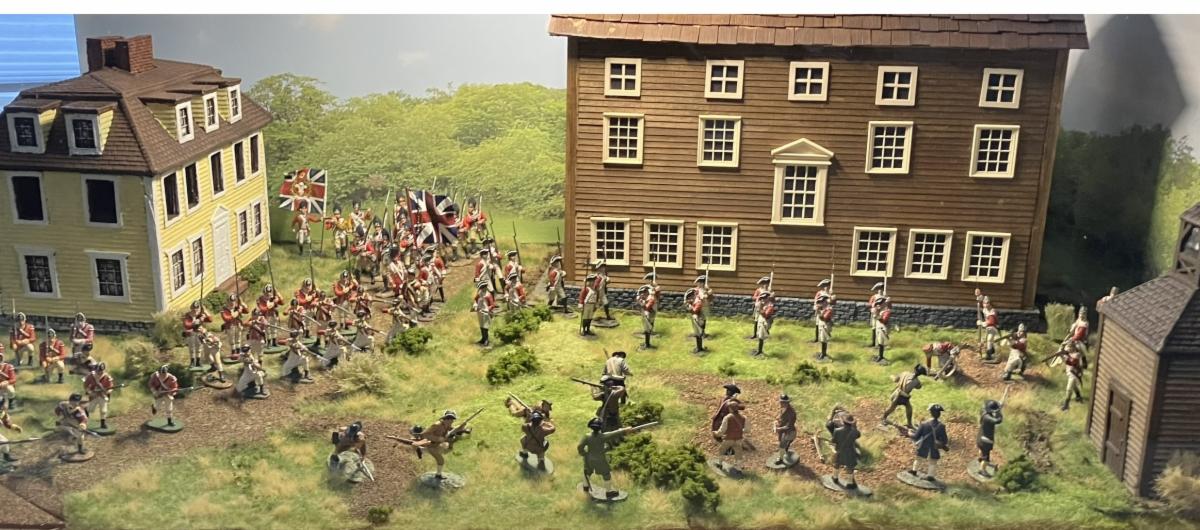 Colonial soldier figurines in front of two houses