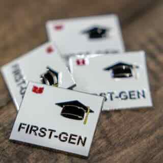 First Generation Student Pins on a Table