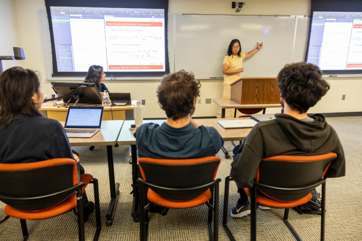 Students study data related to black holes in a Grinnell classroom