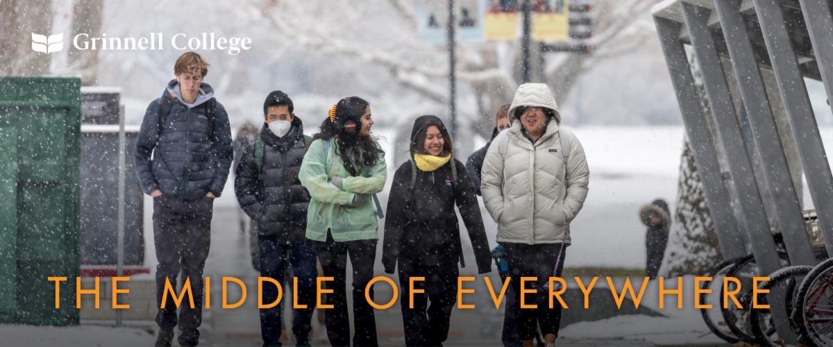 Students walk along 8th Avenue in a snowstorm