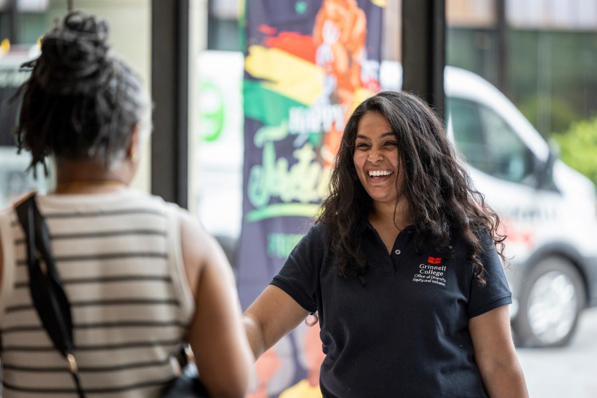 Associate Chief Diversity Officer for Intercultural Affairs Vrinda Varia greets a community member