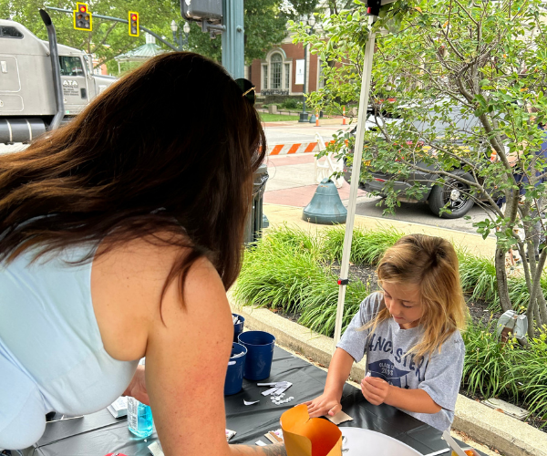Photo of children making a craft at the Lancaster Day of Action event. 