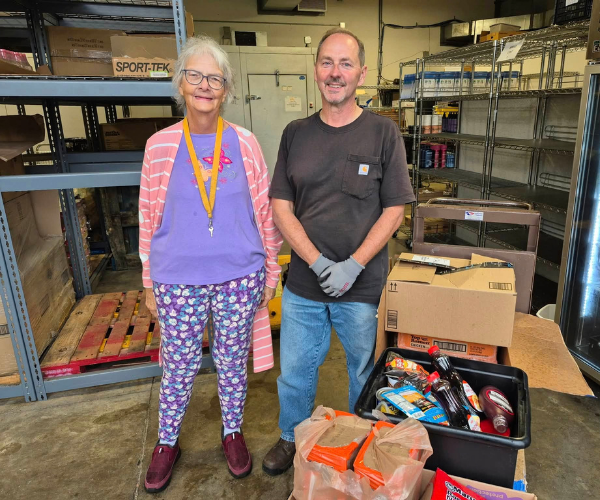 Photo of volunteers at the Lutheran Social Services collecting donated food items.