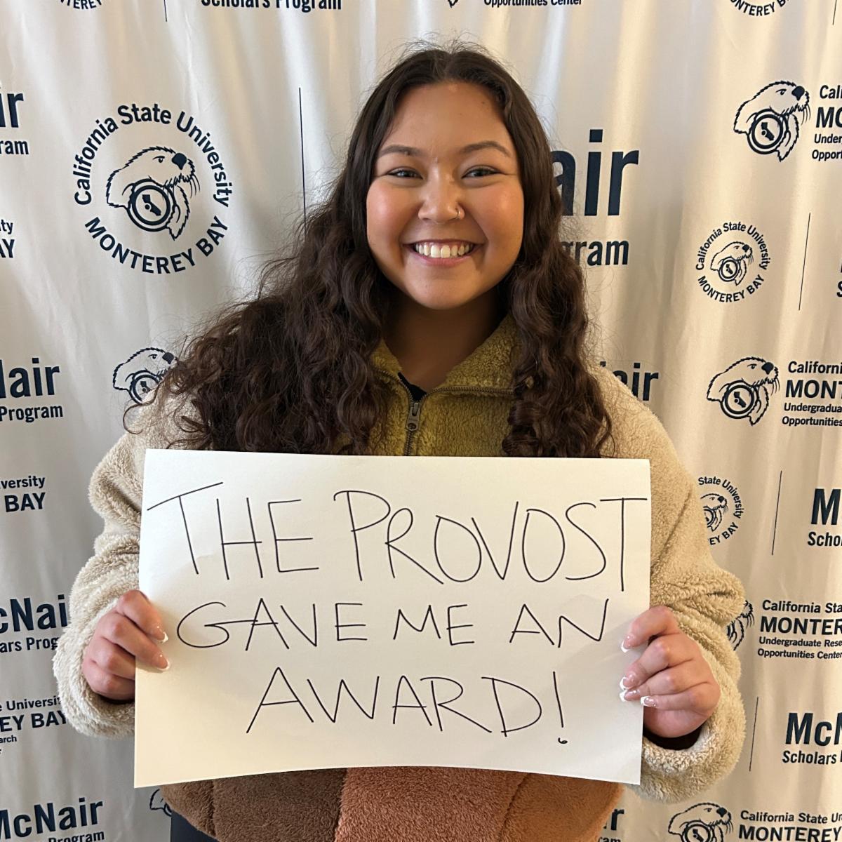 Sarina Regis holding sign