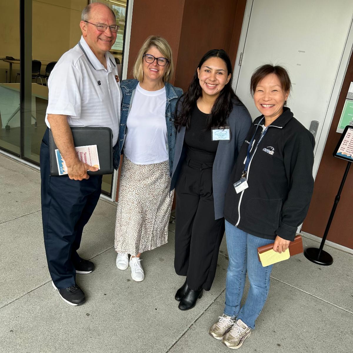 Berenice stands with College of Business faculty