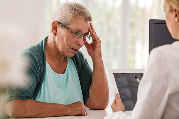 Older woman looking worried in conversation with doctor