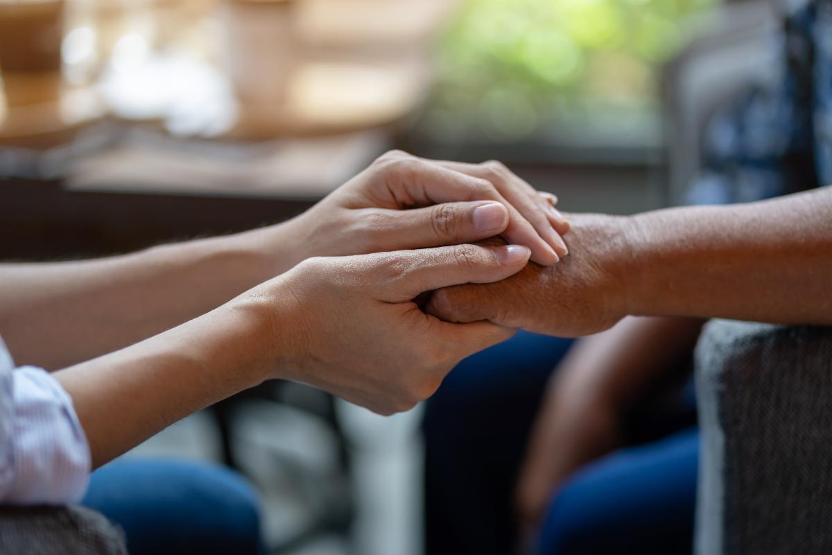 younger hands holding older hands