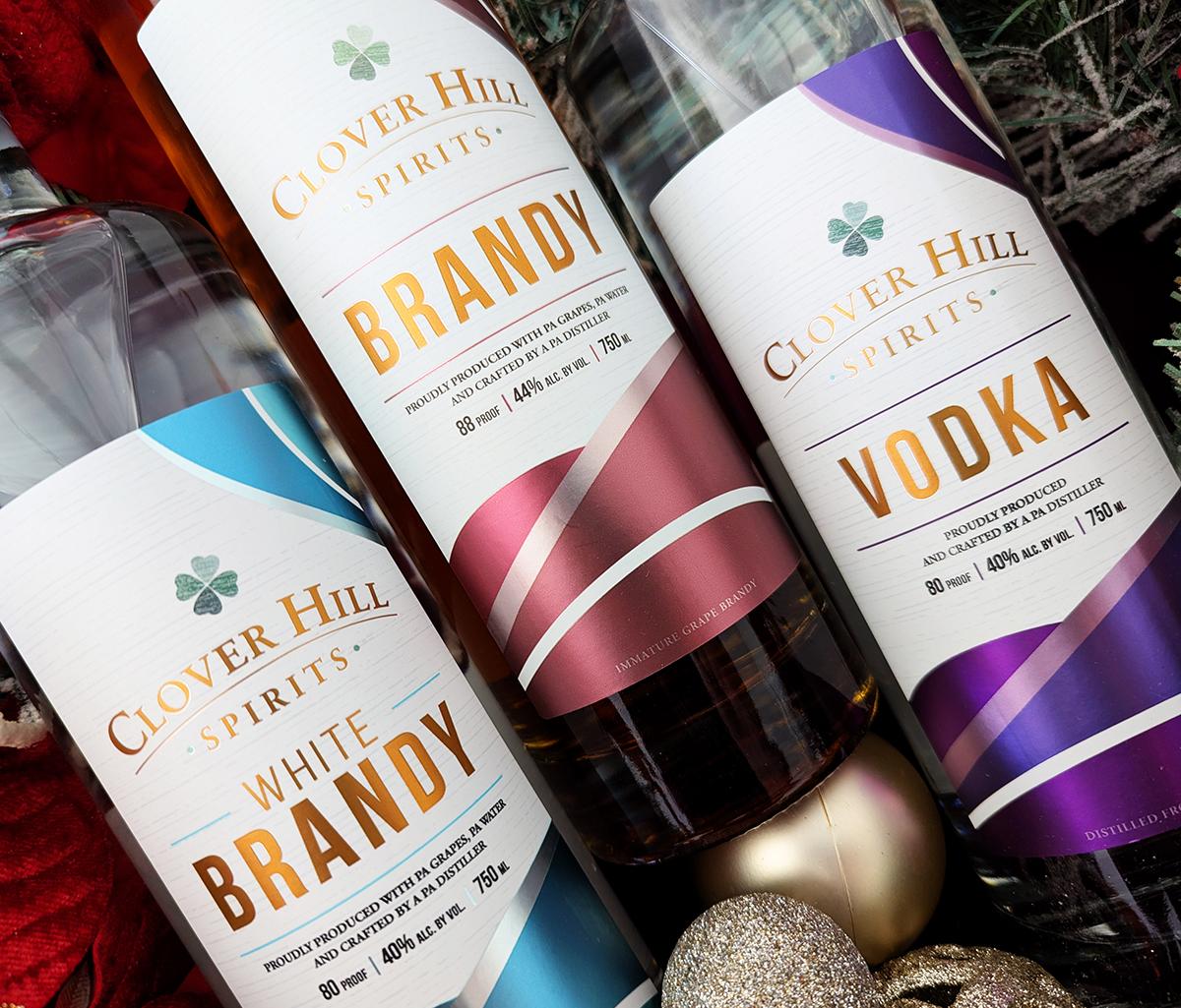 Close up of bottles of Clover Hill Spirits White Brandy, Brandy and Vodka