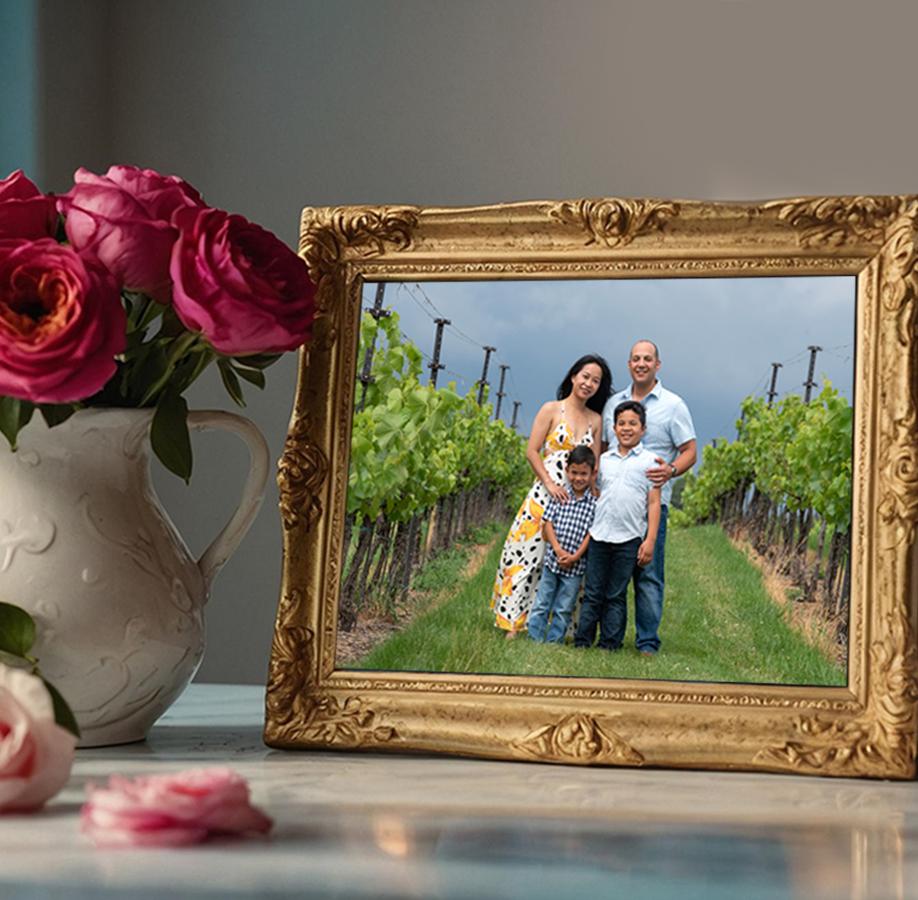 vase of flowers next to framed photo of family in the vineyard at Clover Hill Winery