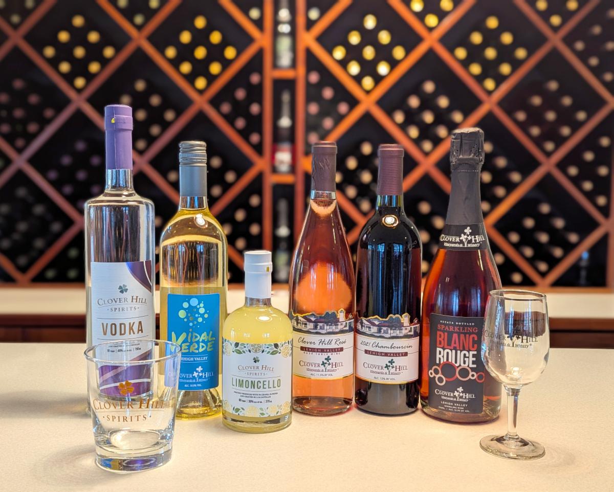 Bottles of Clover Hill wines and Clover Hill Spirits in a line on the tasting bar
